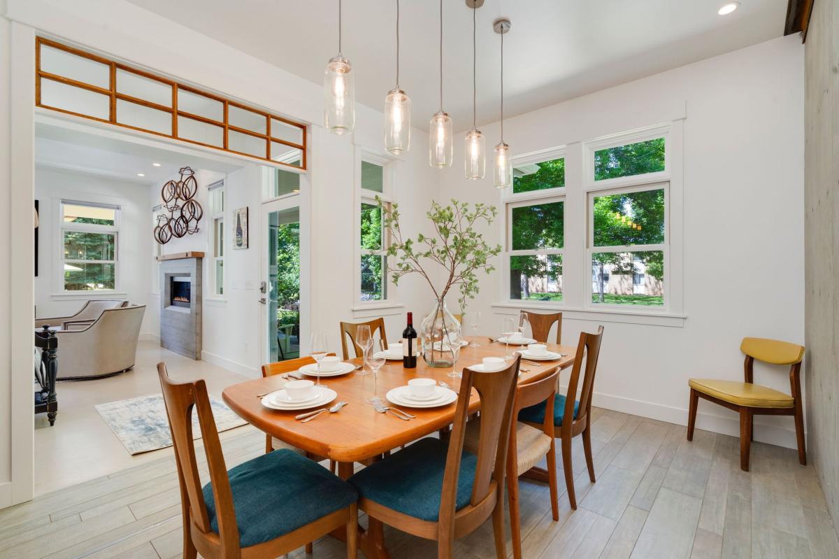 A dining room with beautiful light fixture over dining room table