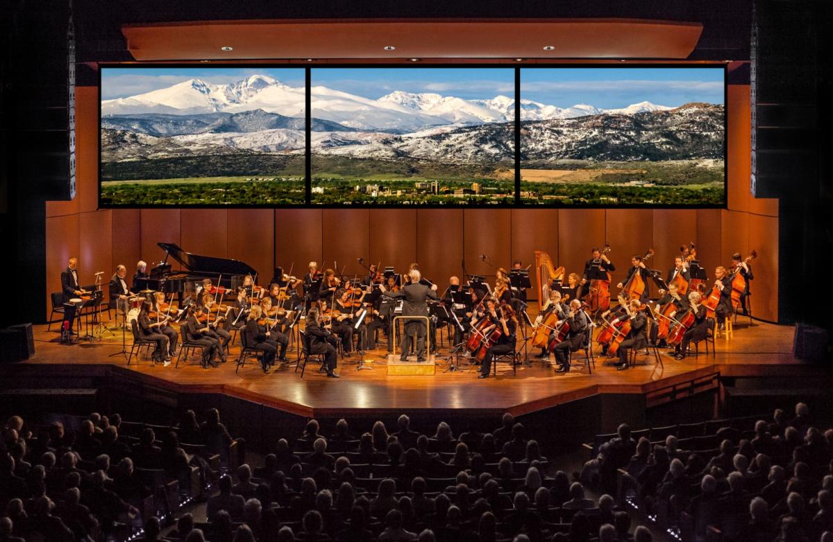 Image of the fort collins symphony playing with rocky mountains in the background