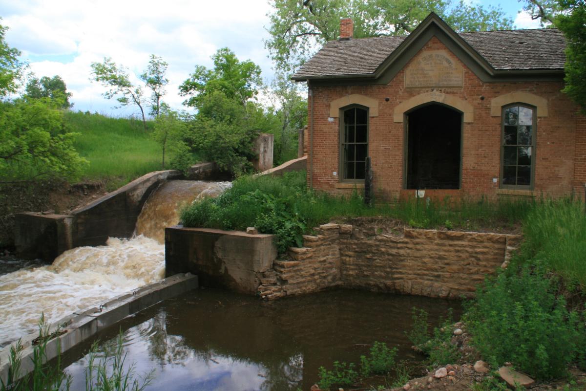 Historic building with water rushing by it